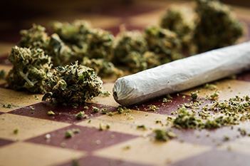 Scattered weed and a joint to represent New Jersey's new marijuana laws